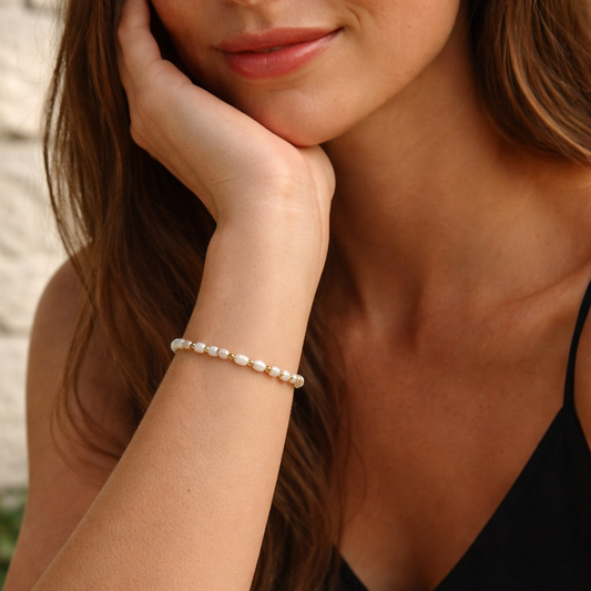 IVY Pearl Bracelet worn on wrist, natural freshwater pearl and 18K gold PVD bead stretch bracelet – CCaura
