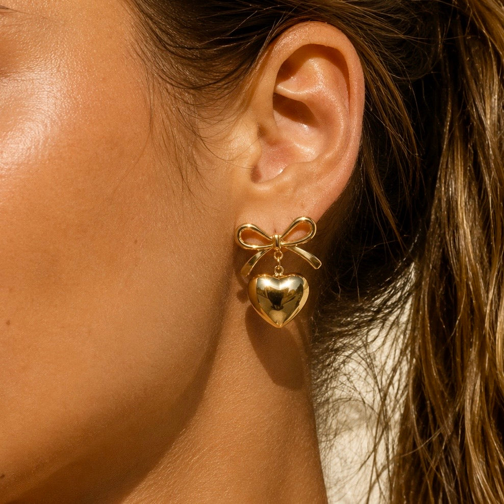 MINI Bow Heart Gold Studs worn by model – CCaura.