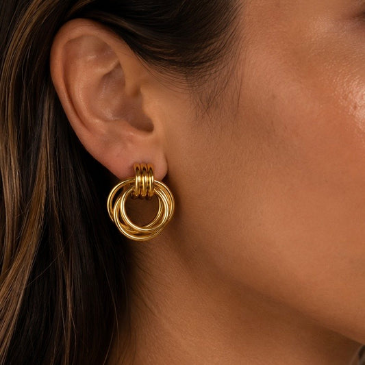 SELENE GOLD EARRINGS, 18K Gold PVD multi-ring interlocked circle drop stud earrings, worn by model, CCAura