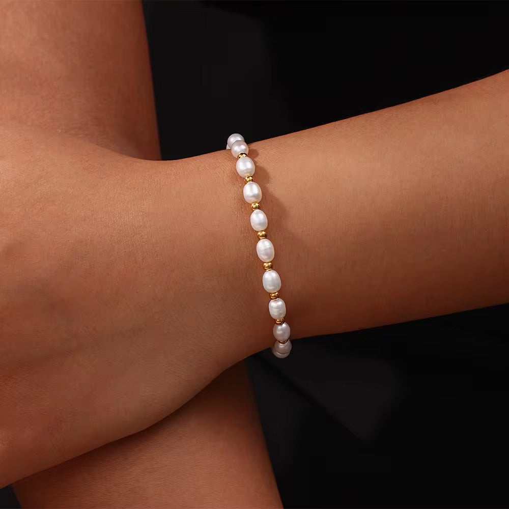 LUNA Pearl Bracelet worn on wrist, natural freshwater pearl and 18K gold PVD bracelet with adjustable sliding clasp – CCaura