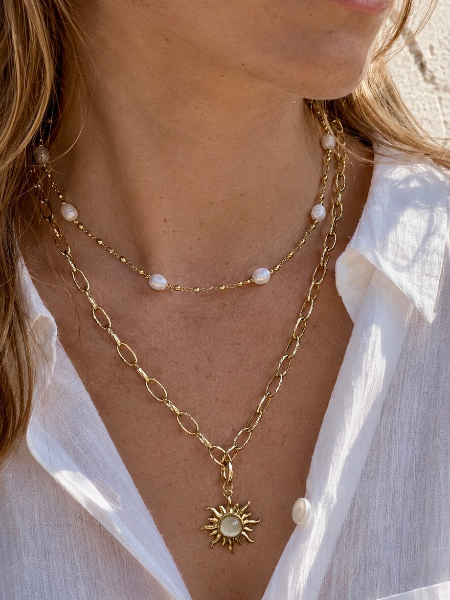 Double necklace - Freshwater pearl and Gold sun pendant necklace wearing a white linen shirt
