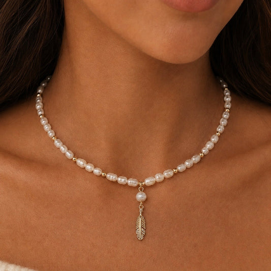 MARINA FEATHER PEARL NECKLACE -1Hi grade freshwater pearls, 18K Gold PVD  beads necklace with a hanging gold plated feather filled with cubic zirconia detailing /worn by model- CCAura
