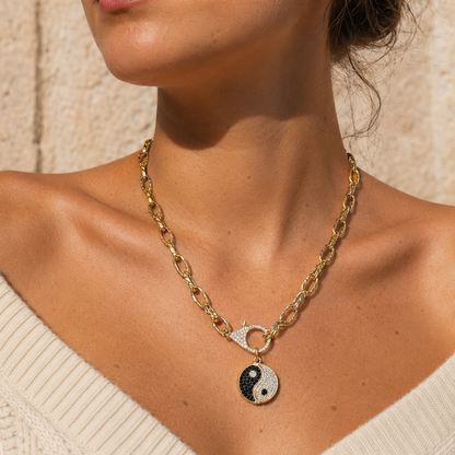 Yin Yang Gold Necklace with 18K gold PVD coating, pavé clasp and ying yang charm worn by model - CC Aura
