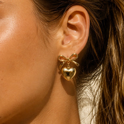 MINI Bow Heart Gold Studs worn by model – CCaura.