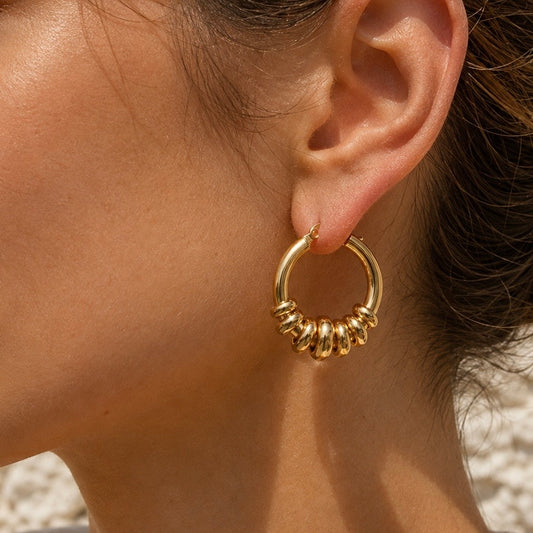 OASIS Gold Hoops worn  by model outdoors– CCaura