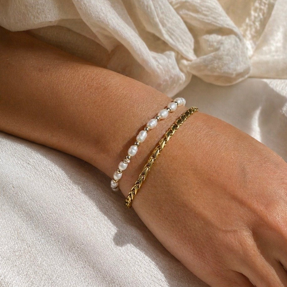 IVY Pearl Bracelet worn on wrist layered with a gold bracelet natural freshwater pearls and 18K gold PVD bead stretch bracelet – CCaura