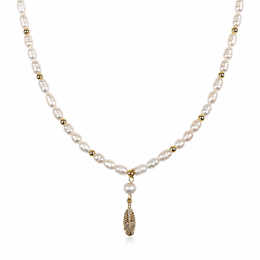 MARINA FEATHER PEARL NECKLACE -1Hi grade freshwater pearls, 18K Gold PVD  beads necklace with a hanging gold plated feather filled with cubic zirconia detailing /on white background. CCAura